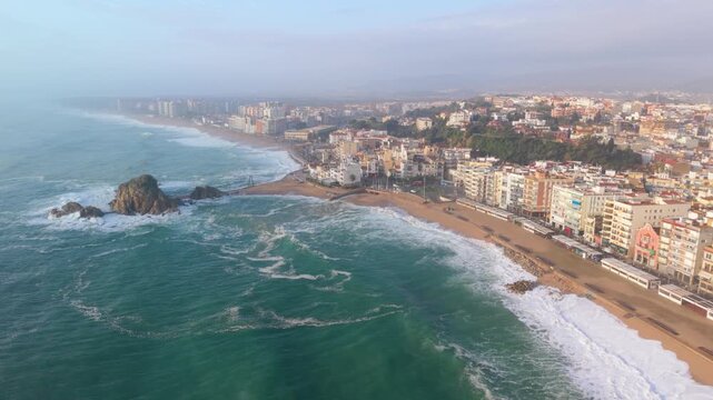 Aerial view of blanes beach with a rough sea storm