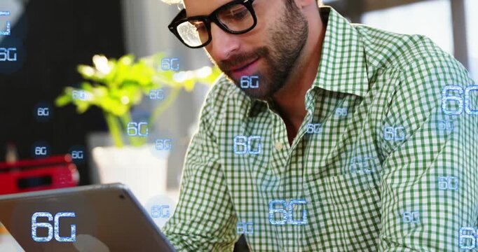 Animation of multiple 6g text over smiling caucasian man watching video on digital tablet in cafes