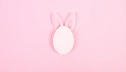 Fototapeta premium White egg with bunny ears on pink background