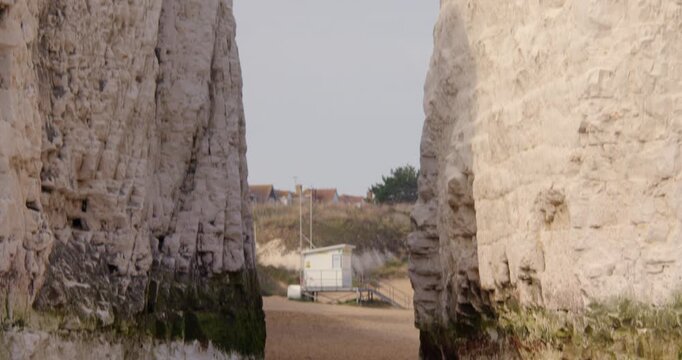 Wide shot tilting up in between two chalk stacks at Botany Bay Beach at low tide. At marine Drive, Broadstairs