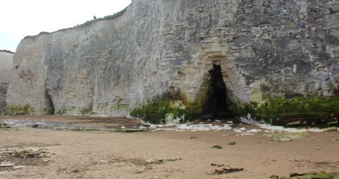 White short of a cave exposed at low tide botany Bay beach with Chalk cliffs. At marine Drive, Broadstairs