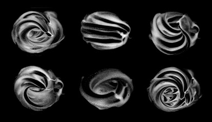 Abstract black and white foam swirl textures isolated on dark background, creative liquid patterns...