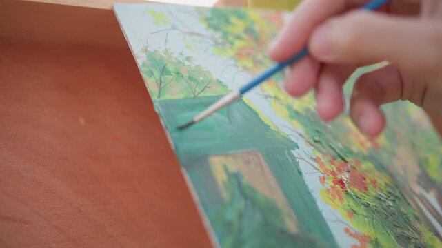 closeup painted cottage and garden on canvas nestled in portable easel warm backlight delicate brushwork visible textured impasto small travel studio outdoors relaxed contemplative mood