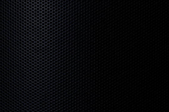 Black Perforated Metal Mesh Texture Background,Close-up of a black metallic speaker grille or perforated steel sheet featuring a repetitive circular hole pattern with dramatic side lighting and dark 