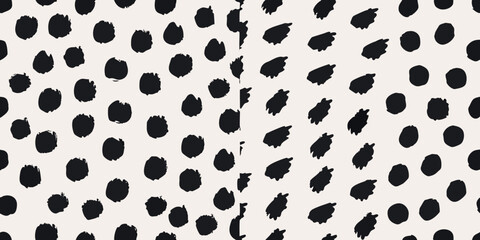 Abstract black spots on a cream colored background creating a playful pattern © SreemotiRaba