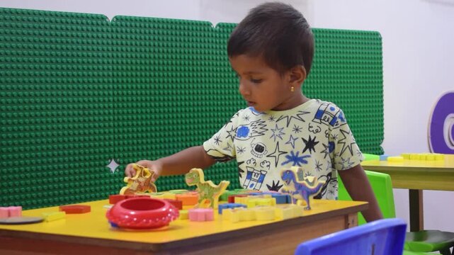 Indian toddler playing with colorful toys in a preschool classroom, smiling and learning through fun activities. Early childhood education, innocence, curiosity, growth, and joyful school moments.