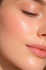 Fototapeta premium Close-up of woman's glowing skin and soft smiling lips