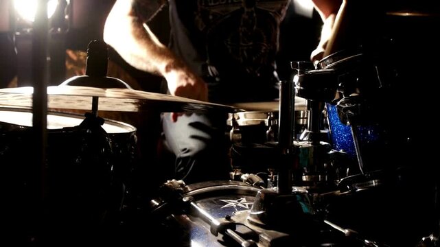Close up Drummer playing on drum set drum Drum Cymbals black clothes sits behind a drum kit and beats drumsticks on different cymbals hihat rythm