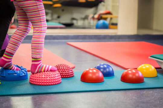 Child balancing on sensory pods improving motor skills