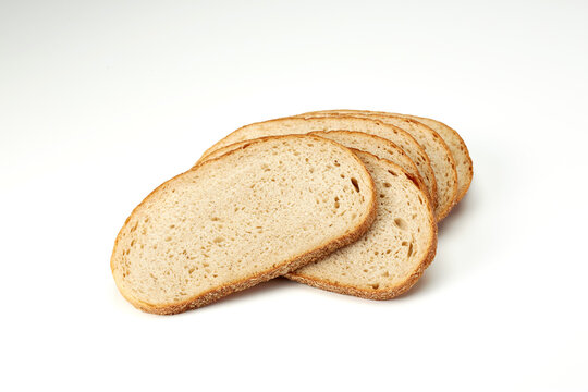 Freshly cut wheat bread slices on white background