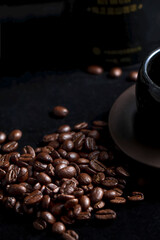 A close-up view of roasted coffee beans and a cup