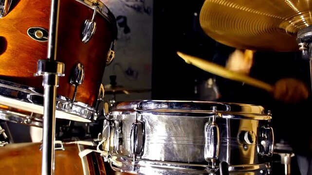 Musician with cymbal and music instrument hobby Beautiful Young Drummer Playing at a Band Rehearsal Among the items on the drum kit is a tambourine