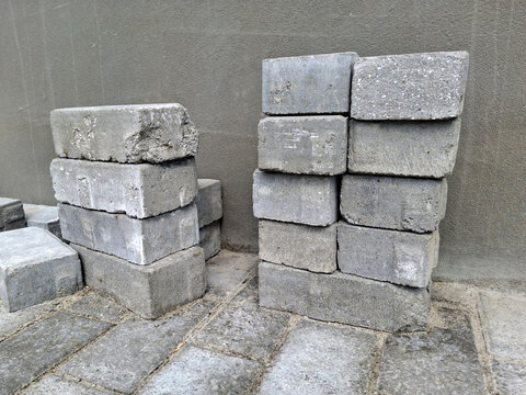 Grey paving slabs are used to create a new sidewalk