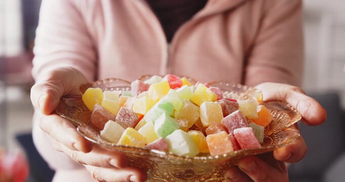Visiting relatives and offering candy during Eid al-Fitr celebration