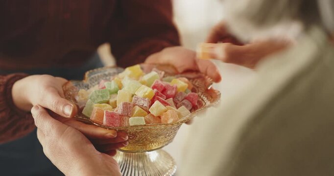 Visiting relatives and offering candy during Eid al-Fitr celebration