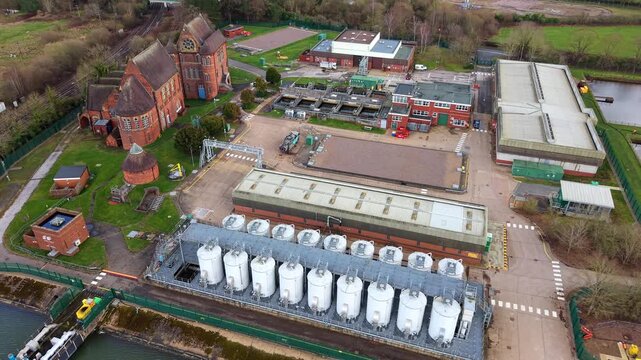 Top down aerial of a British sewage wastewater recycling centre in Birmingham highlighting industrial sanitation infrastructure and sewage storage silos.