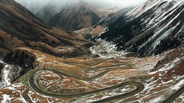 Aerial view of winding mountain road at Suyek Pass in Kyrgyzstan 