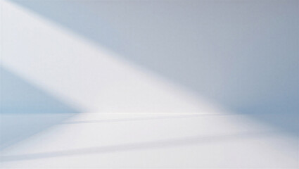 Minimalist white wall background with a sharp diagonal beam of sunlight