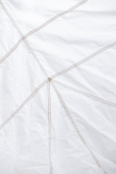 Geometric pattern of seams on white reinforced nylon fabric