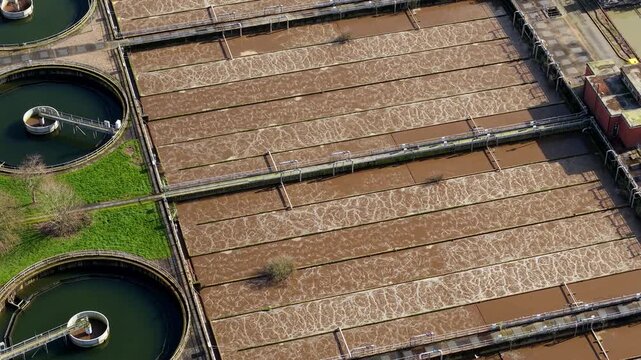 Top down aerial view of aerobic digestion ponds at a sewage treatment works in the Soar Valley UK with active water aeration.
