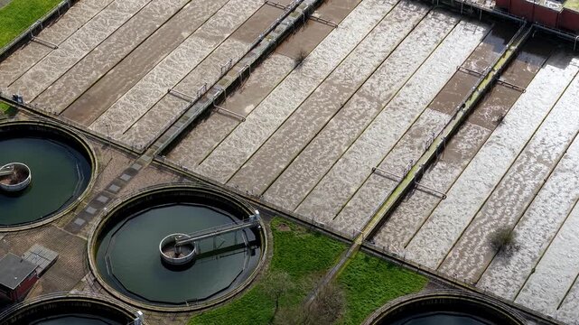 Top down aerial view of aerobic digestion ponds at a sewage treatment works in the Soar Valley UK with active water aeration.