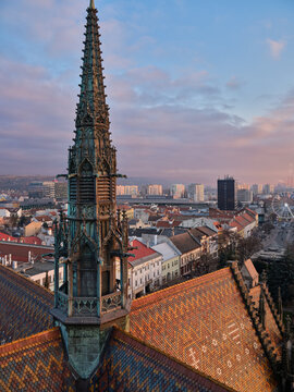 Kosice Cathedral Gothic Spire And Tiled Roof Over Cityscape At Sunset