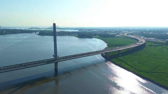 Liverpool, Merseyside, UK, June 19, 2025; Aerial 4K video footage of the Mersey Gateway toll bridge with stunning views over the River Mersey, Liverpool, UK.
