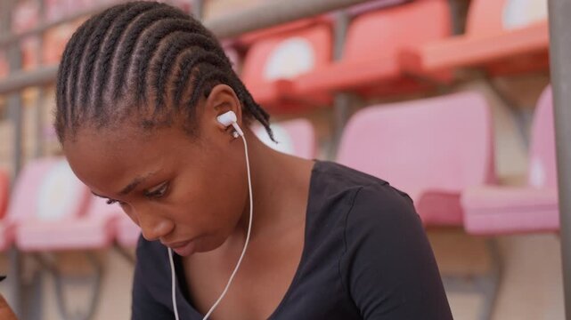Young female preparing for competition mentally. Teenage female athlete concentrates deeply on game tactics. Young girl carefully devises her game plan during highpressure situation