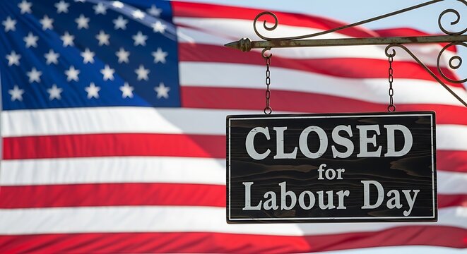 Labor day closed sign in front of american flag celebrating workers' holiday