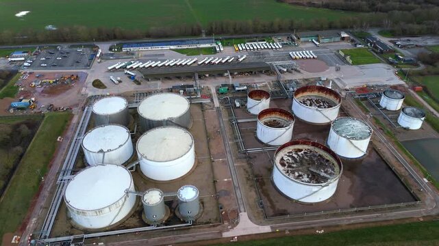 Aerial drone view of a massive UK energy storage facility, featuring vast rows of oil tanks and gas reserves for national fuel security.