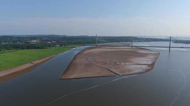 Liverpool, Merseyside, UK, June 19, 2025; Aerial 4K video footage of the Mersey Gateway toll bridge with stunning views over the River Mersey, Liverpool, UK.