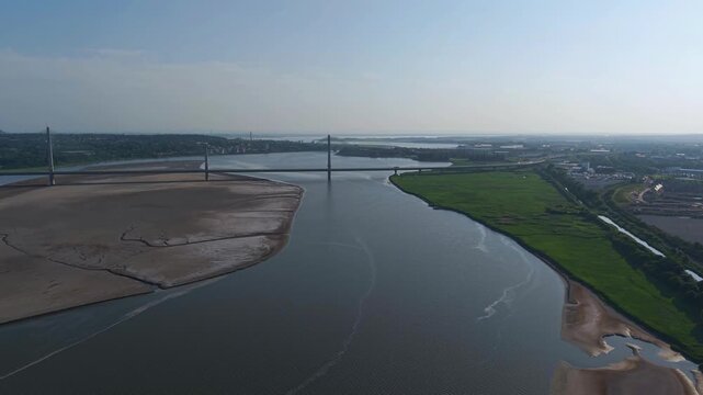 Liverpool, Merseyside, UK, June 19, 2025; Aerial 4K video footage of the Mersey Gateway toll bridge with stunning views over the River Mersey, Liverpool, UK.