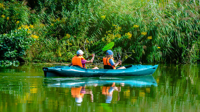 Youth floating in a canoe on the river
