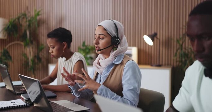 Headset, laptop and talking with woman in call center for assistance, help or online support. Computer, customer service and explain with agency employee in office for contact, feedback or solution