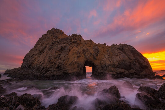 Dramatic sunset over Keyhole Arch at Big Sur, Pfeiffer Beach State Park, California, USA