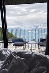 Fototapeta premium View from a room with balcony over the Ultental (Val d'Ultimo) with sun rays, clouds and snowcapped Alps in South Tyrol, Italy