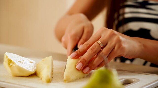 Slicing a pear in the kitchen with simple tools and clear steps in a home setting