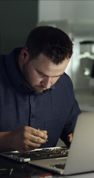 Frustrated, man and technician with laptop for repair, fixing electrical components or wrong tools. Tired, male person or IT service with bad circuit board on computer for troubleshooting hardware