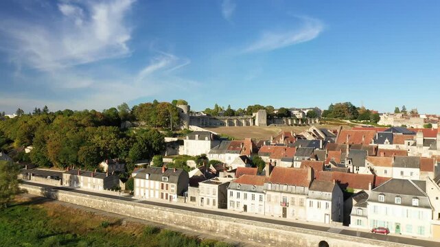 Scenic aerial shot of historic rooftops and medieval architecture in La Charite sur Loire, France on a clear sunny day.