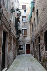 Fototapeta premium Narrow alleyways brick path cobblestone Venezia August 2024