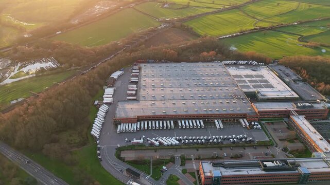 Aerial view of a huge logistics distribution centre in Atherton Greater Manchester with HGVs lined up at loading bays for export UK
