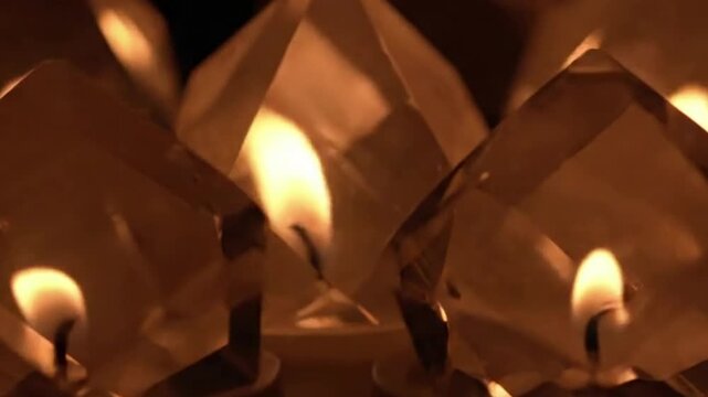 Ethereal Polygon Glow Focus on a single, complex geometric object (e.g., an octahedron) slowly rotating in darkness, its facets catching and softly emitting an ambient firelight twinkle.