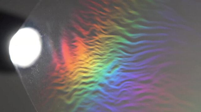 Optical Interference Visualization A controlled, clean studio shot demonstrating the interference of light waves, with distinct, clear bright and dark fringes or colorful spectra cast onto a neutral