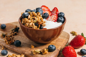 Greek yogurt bowl with granola and fresh berries. A healthy breakfast bowl of creamy yogurt topped...
