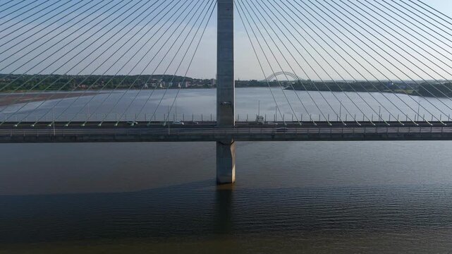 Liverpool, Merseyside, UK, June 19, 2025; Aerial 4K video footage of the Mersey Gateway toll bridge with stunning views over the River Mersey, Liverpool, UK.