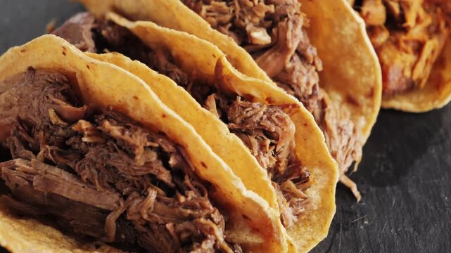 Delicious tasty taco with stewed beef and beans, spicy sauce Valentina and creamy sauce, sauce pico de gallo. Mexican cuisine concept.
