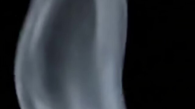 Whispering Current Multiple thin, parallel, gentle smoke ribbons slowly coiling and flowing in unison across the frame on an unlit, dark backdrop.