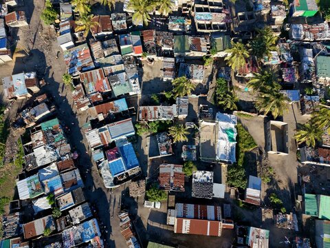 Aerial overhead tin shacks in a shantytown