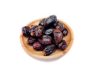 heap of dates on wooden plate