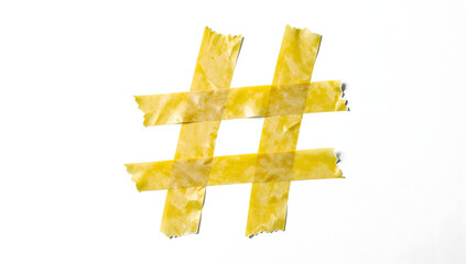 Obraz premium Hashtag Creation: A vibrant # symbol, crafted from tape, symbolizes connection and trends in a visually compelling presentation.